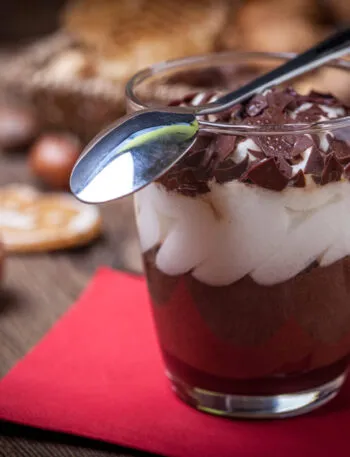 Mousse al cioccolato servita in bicchiere con crema soffice e scaglie di cioccolato, tra i dolci al cucchiaio più amati del 2026