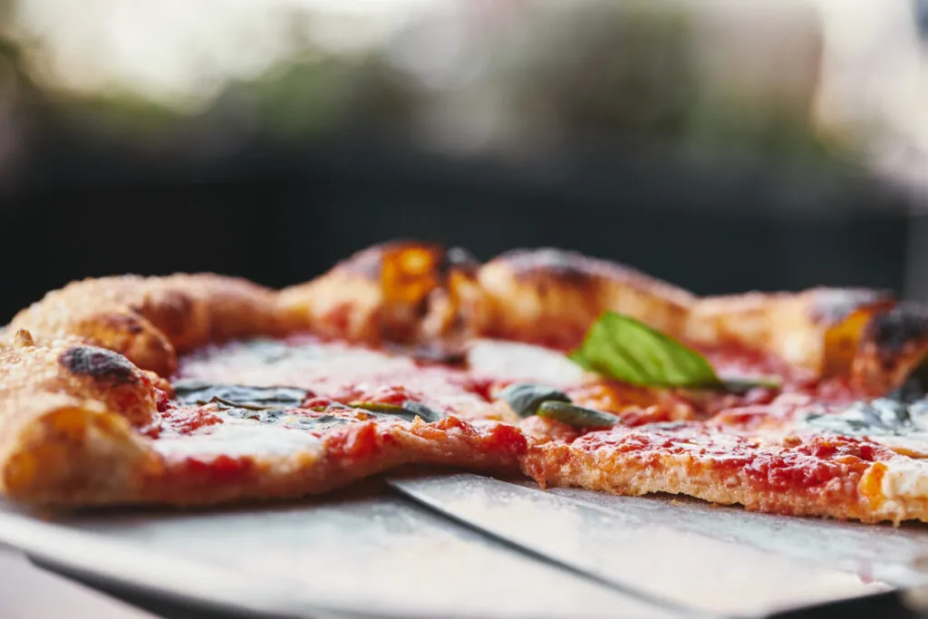 Pizza napoletana margherita leggera con mozzarella, pomodoro e basilico, esempio di cucina campana in versione fit.
