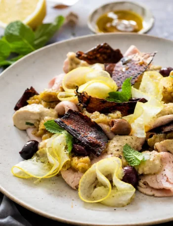 Arrosto freddo di vitello con melanzane, tahina, limone, menta e olive taggiasche