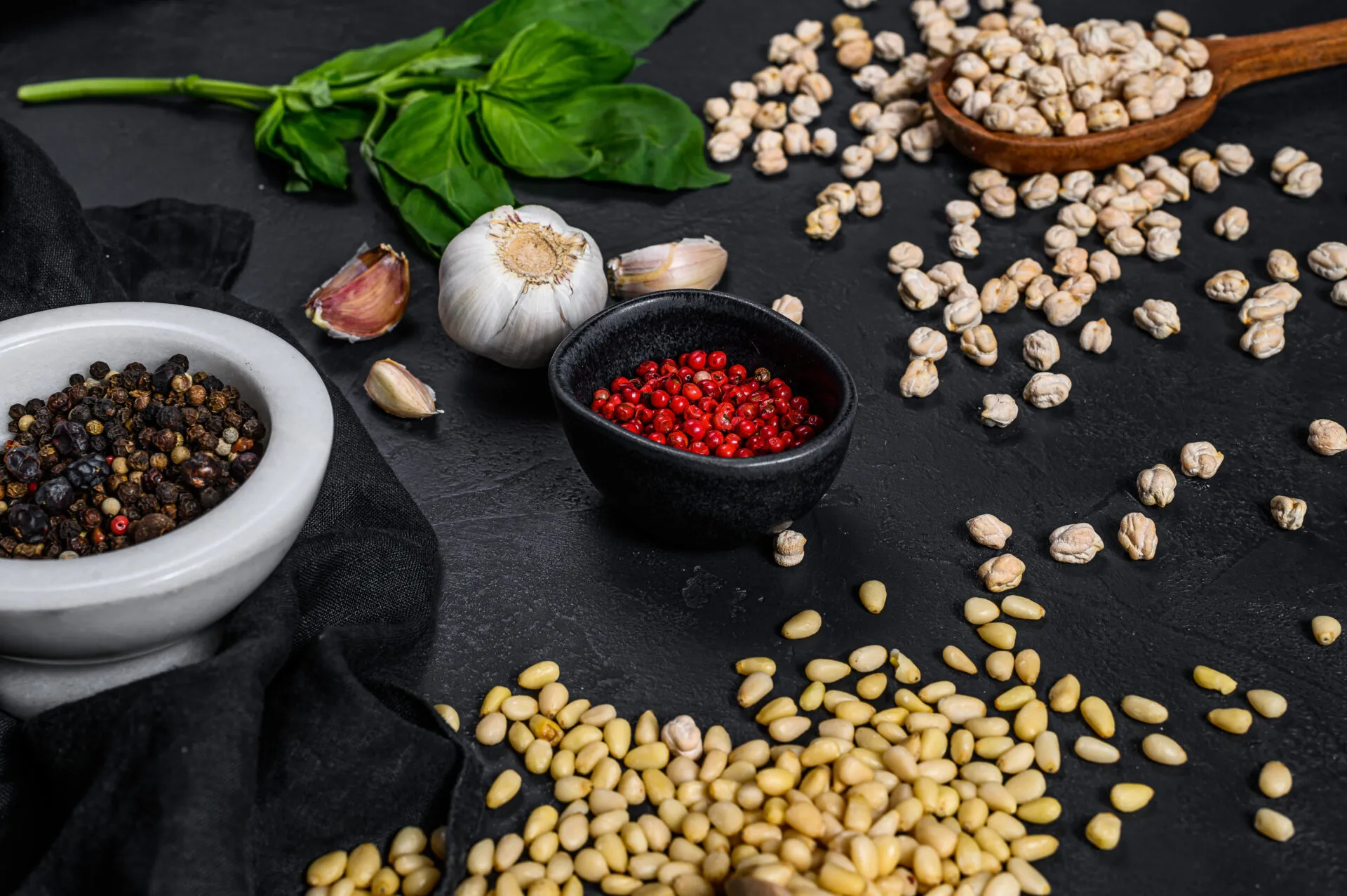 Ingredienti per ricette con legumi fit con ceci, spezie, basilico e aglio su piano da cucina