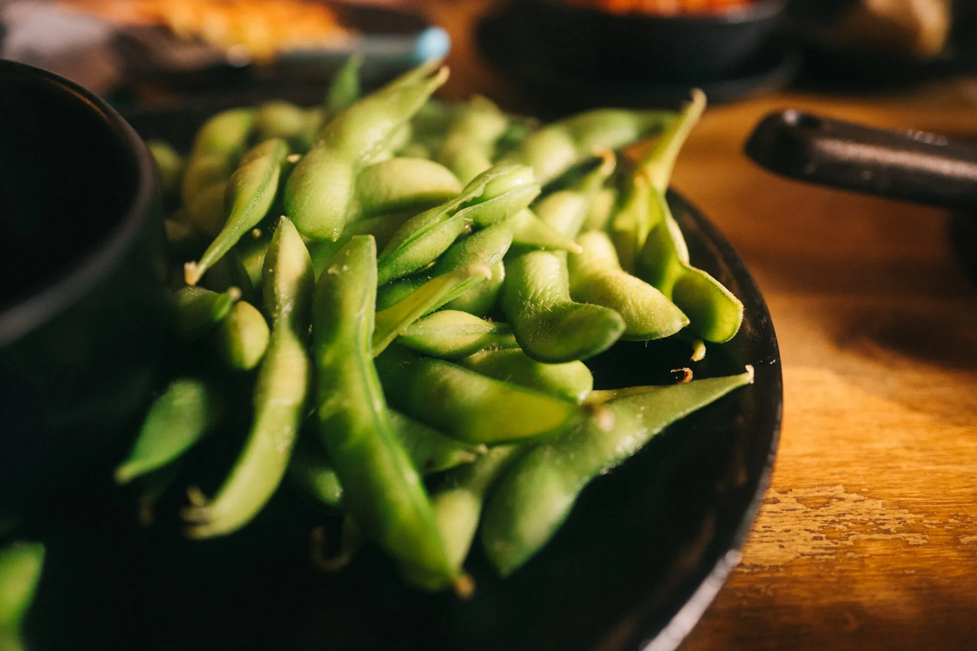 Baccelli di edamame verdi in una ciotola scura